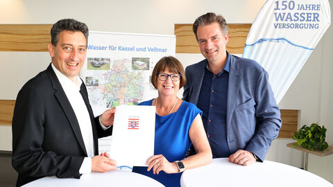 Drei Personen mit Förderbescheid. 