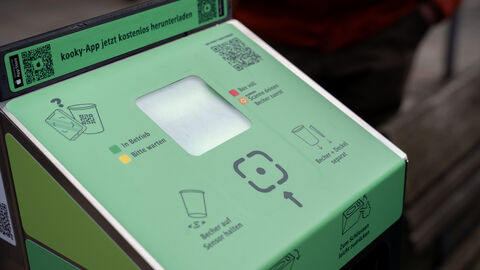 Grüne Rückgabe Box mit Erklärung. 