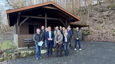 Eine Gruppe Menschen vor der Rabenkopfhütte in Schenklengsfeld.